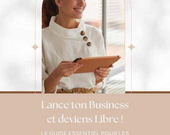 May include: A woman holding a brown tablet, wearing a white blouse with brown buttons. The image includes text that says "Lance ton Business et deviens Libre!" and "Ton ebook". The website www.reallygreatsite.com is also visible.