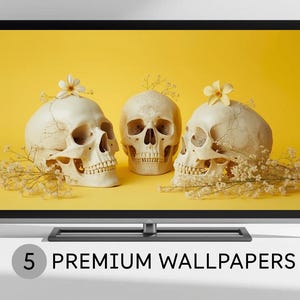 Puede incluir: Una pantalla digital muestra tres calaveras humanas con flores y ramitas sobre un fondo amarillo. Las calaveras son blancas y tienen pequeñas flores encima. El texto "5 PREMIUM WALLPAPERS" está en la parte inferior de la pantalla.