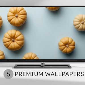 May include: A flat-screen TV displays a wallpaper featuring several orange pumpkins on a light blue background. The text "5 PREMIUM WALLPAPERS" is displayed at the bottom of the screen.