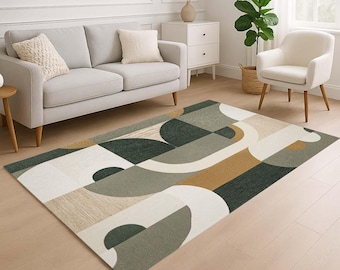 May include: A rectangular area rug with a geometric pattern in shades of green, beige, gray, and brown. The rug features curved and angular shapes, creating a modern design. The rug is placed on a light-colored wooden floor.