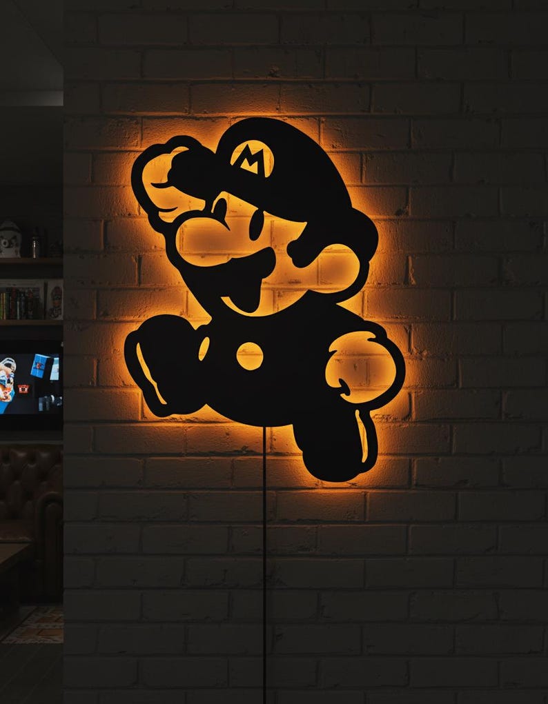 K&ouml;nnte beinhalten: Schwarze Silhouette einer springenden Videospiel-Figur mit orangefarbener Beleuchtung. Die Figur ist an einer Ziegelmauer befestigt. Die Figur tr&auml;gt einen Hut mit einem "M" darauf.