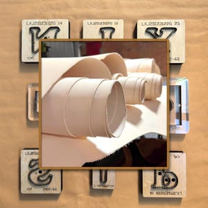 May include: Rolled beige leather and wooden stamps are shown in a close-up. The stamps have the text "LXJ25123122G 14", "LXJ25123122G 12", "LXJ25123122G 25", "ZM02-60", and "LXJ251231226 16". The leather is in a rectangular frame.