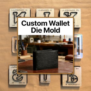 May include: A black leather wallet sits on a brown surface, surrounded by wooden die molds. The molds have various shapes and text, including "Custom Wallet Die Mold." The background shows a workshop setting.