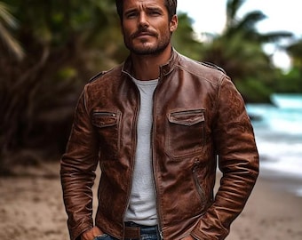 May include: A brown leather jacket with a stand-up collar, a front zipper closure, and two chest pockets with flaps. The jacket is worn over a light gray t-shirt and paired with blue denim jeans, featuring a textured, weathered finish.
