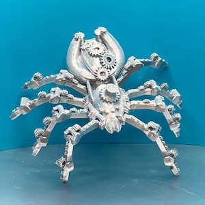 May include: A silver-colored, 3D printed, steampunk-style spider with intricate gears and cogs on its body and legs.