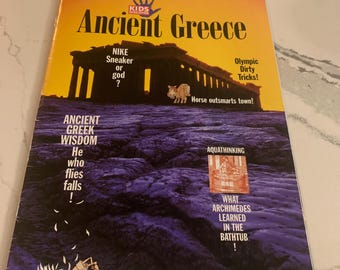 May include: A magazine titled "Ancient Greece" with a yellow and purple cover. The cover features illustrations of Greek architecture and text including "Nike Sneaker or god?" and "What Archimedes learned in the bathtub!"