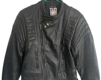May include: Black leather jacket with an asymmetrical zipper closure, multiple zippered pockets, and quilted shoulder detailing. The jacket has a stand-up collar and silver-toned hardware. It is hanging on a green hanger.