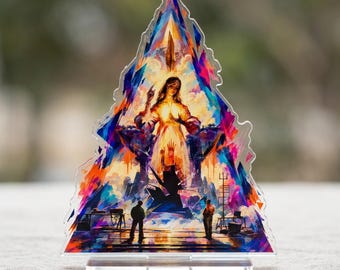 May include: A triangular acrylic standee featuring a vibrant, painterly illustration of a central female figure with raised hands, surrounded by abstract blue, orange, and purple shapes, with two small figures standing at the base.