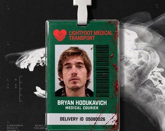 May include: A rectangular green identification badge featuring a red heart-shaped logo, the text LIGHTFOOT MEDICAL TRANSPORT, a photograph of a person, a barcode, and the name BRYAN HODUKAVICH, MEDICAL COURIER, with red blood-like splatters.