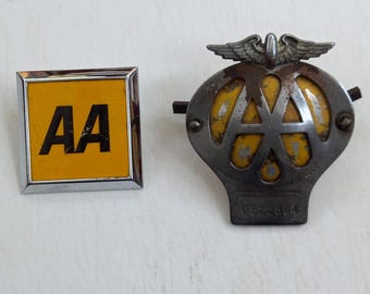Vintage pair of A A members car badges on a journey badge and at home breakdown badge