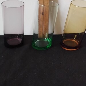 May include: A set of three ceramic canisters with lids. The canisters are white with a blue floral pattern. The largest canister is 20 cm tall, the medium is 18 cm, and the smallest is 15 cm.