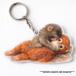 May include: A white ceramic mug with a black handle and the text "But First, Coffee" in a black, bold font. The mug is on a white surface.