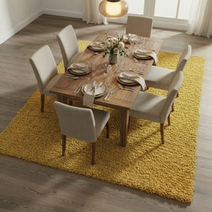 Mustard hand-tufted shag rug in a modern living room; soft yellow solid-color wool rug on light wood floor.