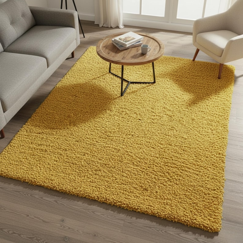 Mustard hand-tufted shag rug in a modern living room; soft yellow solid-color wool rug on light wood floor.