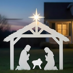 May include: A white metal nativity scene silhouette with a star on top. The scene depicts two figures kneeling beside a manger, all set against a backdrop of a house and a twilight sky. The star is illuminated.