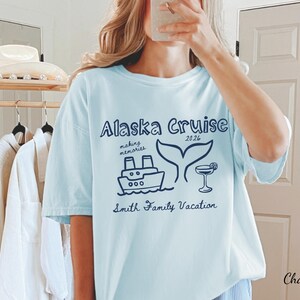 May include: Light blue t-shirt with the text "Alaska Cruise 2026" and a graphic of a ship, whale tail, and cocktail. The shirt also includes the text "making memories" and "Smith Family Vacation".