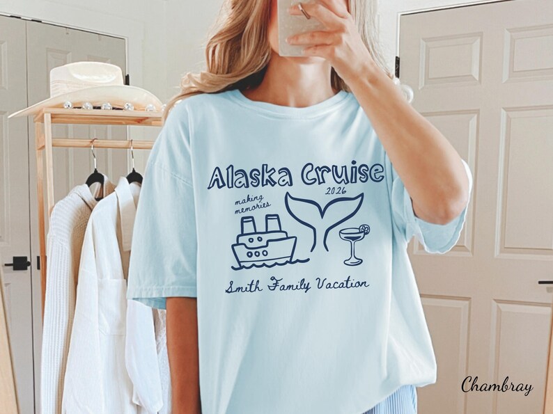May include: Light blue t-shirt with the text "Alaska Cruise 2026" and a graphic of a ship, whale tail, and cocktail. The shirt also includes the text "making memories" and "Smith Family Vacation".