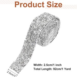 May include: A silver rhinestone ribbon roll featuring a faceted crystal texture. The text Product Size is at the top. The text Width: 2.5cm/1 inch and Total Length: 92cm/1 Yard is at the bottom. The ribbon has a width of 1 inch and a length of 1 yard.
