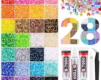 May include: A set of 28 compartments filled with small, multi-colored round rhinestones in various hues. The kit includes three tubes of B-7000 adhesive, a white wax pencil, and black metal tweezers for applying the decorative craft gems.