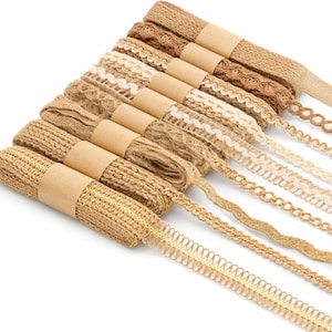 May include: A collection of ten rolls of decorative trim and lace ribbon in various shades of beige, tan, and cream. Each roll is secured with a brown paper band, featuring diverse textures including woven jute, scalloped edges, and braided patterns.