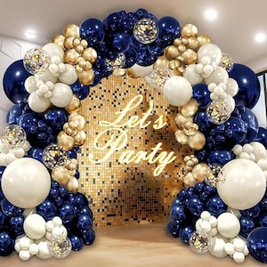May include: A balloon arch in navy blue, gold, white, and confetti-filled balloons. The arch frames a gold sequin wall with the words "Let's Party" in a neon script. Party decorations.