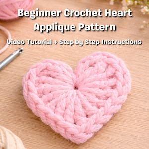 May include: A handmade, light pink crochet heart applique. The heart is made of thick yarn and has a textured appearance. The image includes the text "Beginner Crochet Heart Applique Pattern" and "Video Tutorial + Step by Step Instructions".