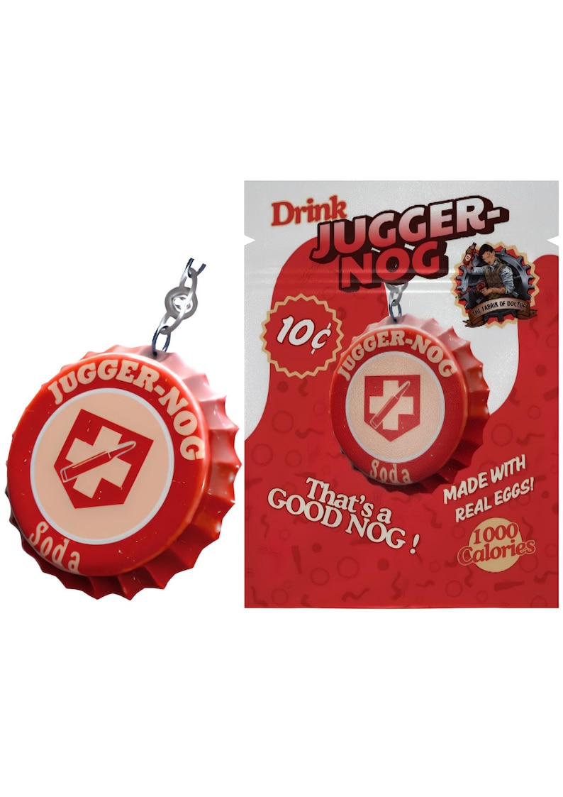 May include: A red and cream-colored JUGGER-NOG soda bottle cap keychain. The cap features the text "JUGGER-NOG Soda" and a crosshair design. The background shows a red advertisement with the text "Drink JUGGER-NOG".