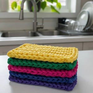 May include: A set of three ceramic mugs with a speckled, matte finish. The mugs are in shades of cream, light gray, and dark gray. Each mug has a simple, minimalist design, perfect for coffee or tea.