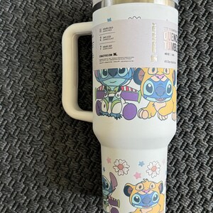 Puede incluir: Vaso Quencher blanco de 1,18 litros con asa y tapa. El vaso presenta un colorido dise&ntilde;o de dibujos animados de Stitch y otros personajes. El vaso est&aacute; dise&ntilde;ado para mantener las bebidas fr&iacute;as durante 11 horas y heladas durante 2 d&iacute;as.