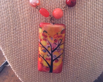 Beautiful orange. red and peach necklace with tree focal