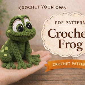 May include: A handmade green crochet frog with large, expressive eyes and a smiling mouth. The frog is sitting on a hand, with a sign that says "Crochet Frog" and "Crochet Pattern". The background is blurred, with plants.