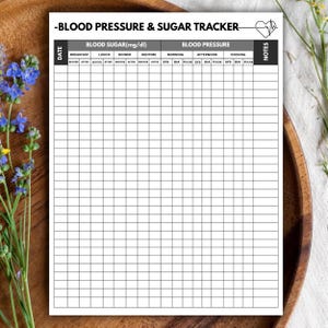 Puede incluir: Una hoja de registro de presión arterial y azúcar en papel blanco con texto y líneas de cuadrícula en negro. El encabezado dice BLOOD PRESSURE & SUGAR TRACKER con un icono de corazón. Las columnas incluyen fecha, azúcar en sangre, presión y notas.