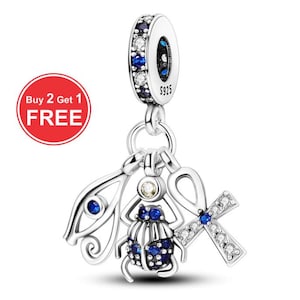May include: A silver charm with Egyptian-themed pendants, including a scarab beetle, an ankh, and an eye of Horus. The charm features blue and clear gemstones. The top ring is marked with "S925". A red circle with the text "Buy 2 Get 1 FREE" is in the image.
