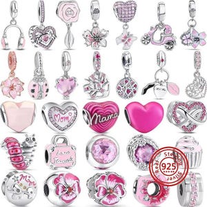 May include: A collection of silver and pink charms for bracelets, featuring various shapes including hearts, flowers, animals, and objects like a scooter and cupcake. Many charms are accented with pink enamel, crystals, and the text Mom or Mama.