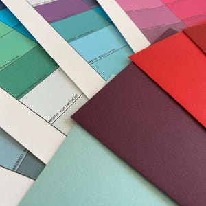 May include: A white ceramic mug with a black handle and the text "But First, Coffee" in a bold, black font. The mug is set against a neutral background, highlighting its simple design.