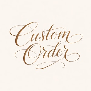 May include: A cream-colored background with the words "Custom Order" written in elegant, flowing, gold-colored calligraphy. The script is ornate and decorative, with flourishes and swirls.