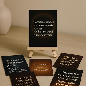 Op de afbeelding: Een houten ezel toont een zwarte kaart met witte tekst: "Vertrouwen is wanneer je stilte boekdelen spreekt." Verscheidene kaarten met inspirerende citaten liggen verspreid.