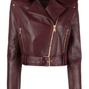 May include: A burgundy leather motorcycle jacket with a notched collar, asymmetrical zip closure, and a belted waist. The jacket features gold-tone hardware, including zippers and belt buckle. The sleeves have zip cuffs and shoulder epaulettes.