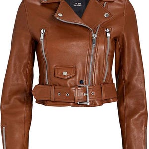 May include: A brown leather motorcycle jacket with a notched collar, asymmetrical zipper closure, and a belted waist. The jacket features silver hardware, including zippers on the sleeves and pockets. The label reads "LTH JKT".