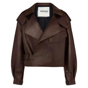 May include: A brown leather jacket with a unique asymmetrical design. The jacket features a notched collar, two front pockets, and a belt at the waist. The label "WANAN" is visible on the inner collar.