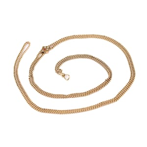 May include: A gold chain necklace with a square pendant featuring red and white stones. The chain is made of multiple strands and has a clasp.