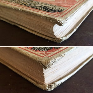 May include: Close-up of the spine of a vintage hardcover book with a red, black, and white design. The book is worn and has a few tears on the spine.