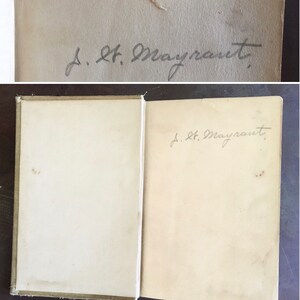 May include: A close-up of the inside cover of a book with a handwritten inscription that reads "J. H. Mayrant."