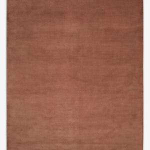 May include: A large, rectangular rug in a solid, warm brown color. The rug has a soft, plush texture and a simple, minimalist design. The rug is suitable for a living room or bedroom.