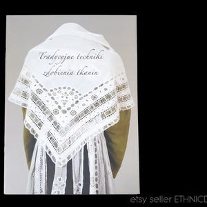May include: A white lace shawl with intricate embroidery and the text "Tradycyjne techniki zdobienia tkanin" (Traditional techniques of fabric decoration).