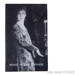 May include: Black and white photograph of a woman in a patterned dress and head covering. The text "HEMLINE, NECKLINE, STREAMLINE" is at the bottom of the image. The Etsy seller's name, ETHNICDRESS, is in the bottom right corner.
