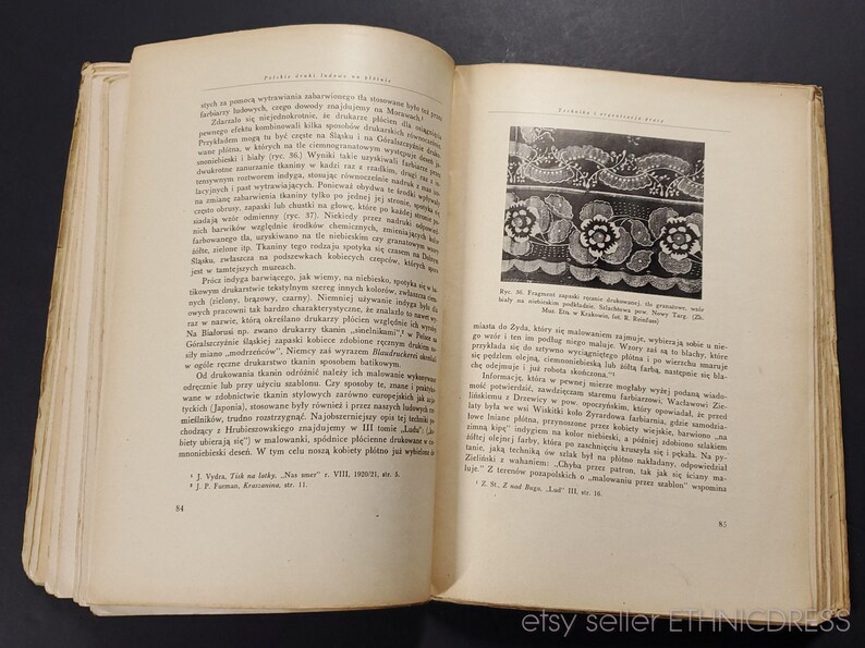 May include: A page from a vintage book about lacemaking, featuring a black and white image of a delicate lace pattern with floral motifs. The text on the page is in Polish.