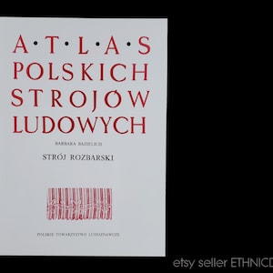 May include: A white book cover with red text. The title reads "ATLAS POLSKICH STROJÓW LUDOWYCH" with the author's name and "STRÓJ ROZBARSKI" below. The bottom of the cover has the text "POLSKIE TOWARZYSTWO LUDOZNAWCZE".