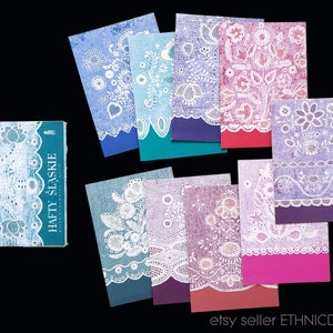 May include: A collection of eight vintage cards featuring white lace embroidery designs on a variety of colored backgrounds. The cards are all rectangular and have a distressed, vintage look. The text on the book reads "HAFTY SLASKIE".