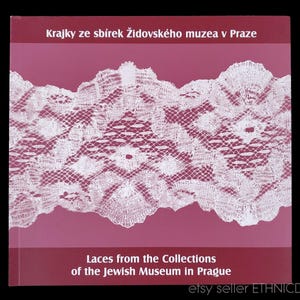 May include: A book cover with a pink background and a white lace pattern. The title is "Laces from the Collections of the Jewish Museum in Prague".